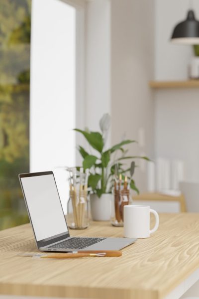 Office interior design with laptop, supplies and decorations on the table beside the picture decorated in the room, 3D rendering, 3D illustration
