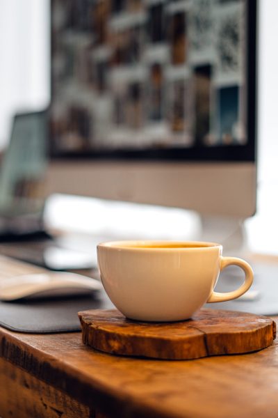 Coffee on the computer desk at home