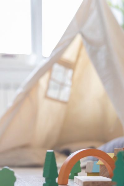 Montessori wooden eco friendly materials construction color bricks towers rainbow arch at childish room interior. Natural ecology playthings building blocks early development skills education leisure